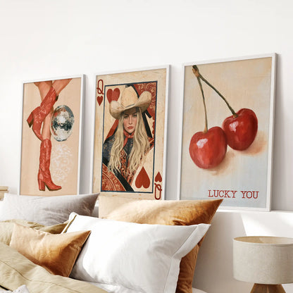 Retro western boots wall art comes as three white-framed prints lined up over the bed, carrying a soft cowgirl theme through the bedroom.