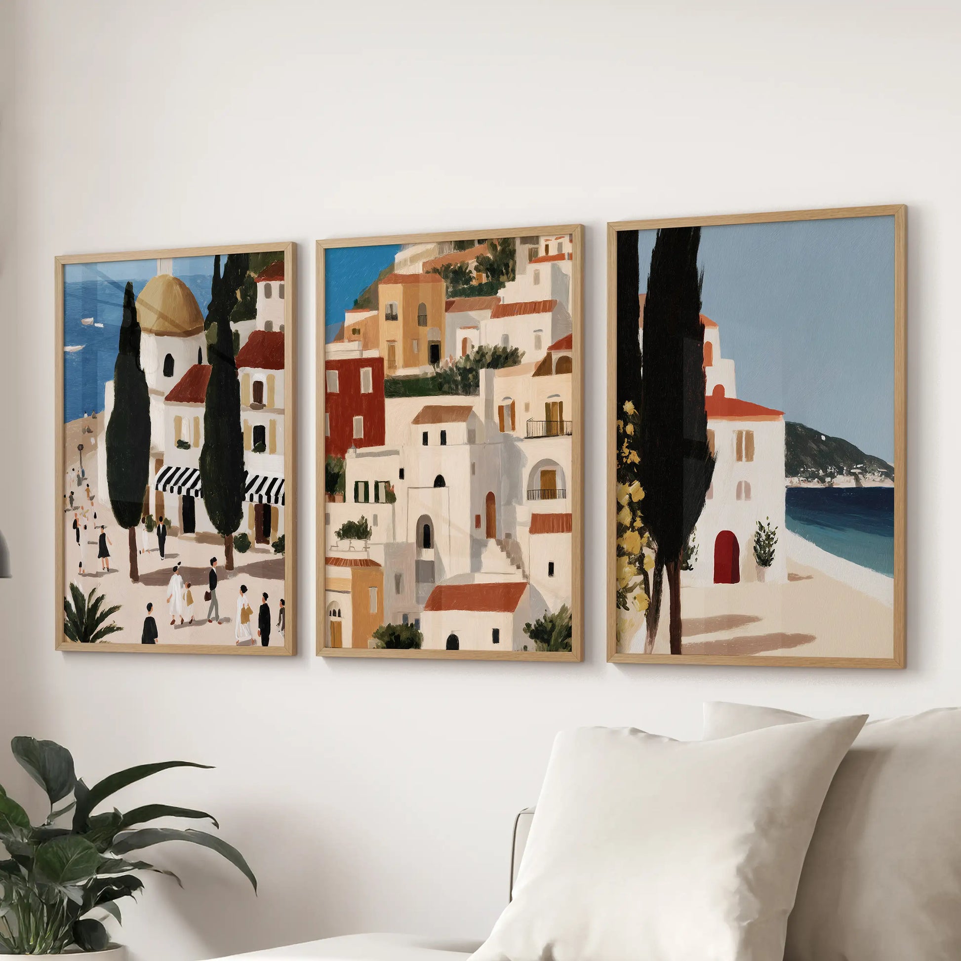 Andalusia Spain travel posters, 3-piece gallery wall in oak frames, stretch above the sofa to bring Mediterranean color and whitewashed architecture to the lounge.