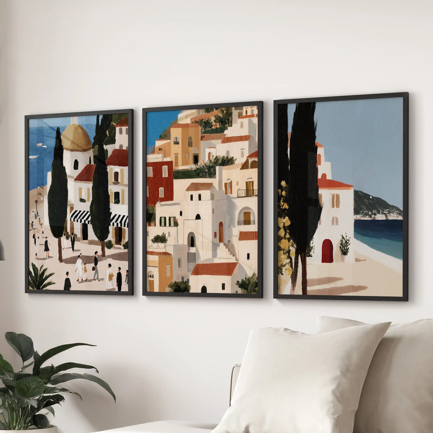 Three black-framed coastline prints make a wall trio above the couch, opening the family room with cool sea horizon energy.