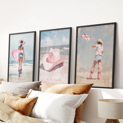Vintage western cowgirl wall hanging set of three art prints in matte black frames, riding high over the headboard to anchor a softly pink bedroom.