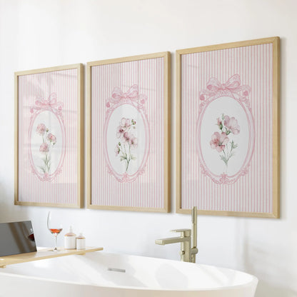 Vintage wildflower botanicals in a three-piece wall art set, with natural oak frames over a freestanding tub in the bathroom.