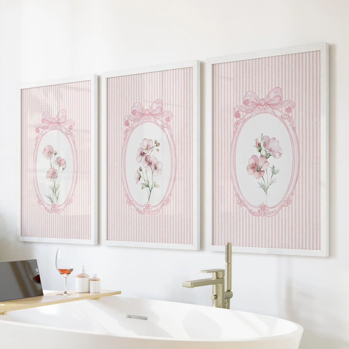 Vintage wildflower botanicals in a gallery wall set of three, white framed and displayed above the bathtub wall in a bathroom.