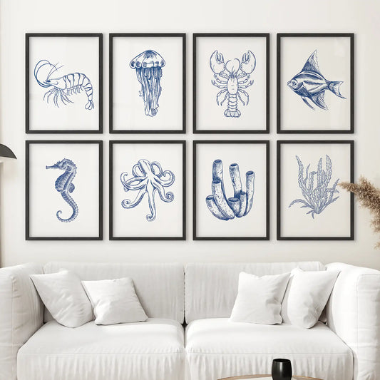 Set of 8 blue nautical wall art prints with sea creatures like lobster, octopus, and jellyfish. Black frames over the couch.