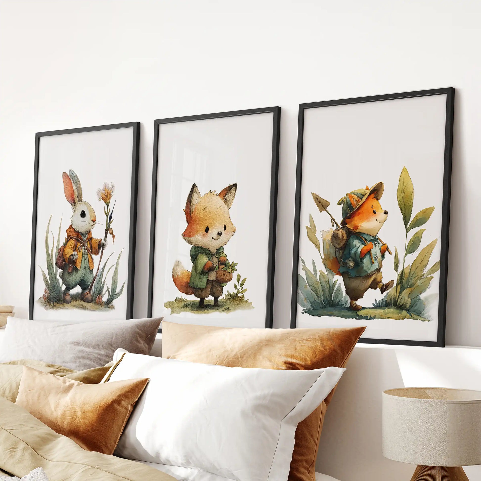 Set of three black-framed watercolor animal artworks centered above the bed adds a soft forest accent to the bedroom.
