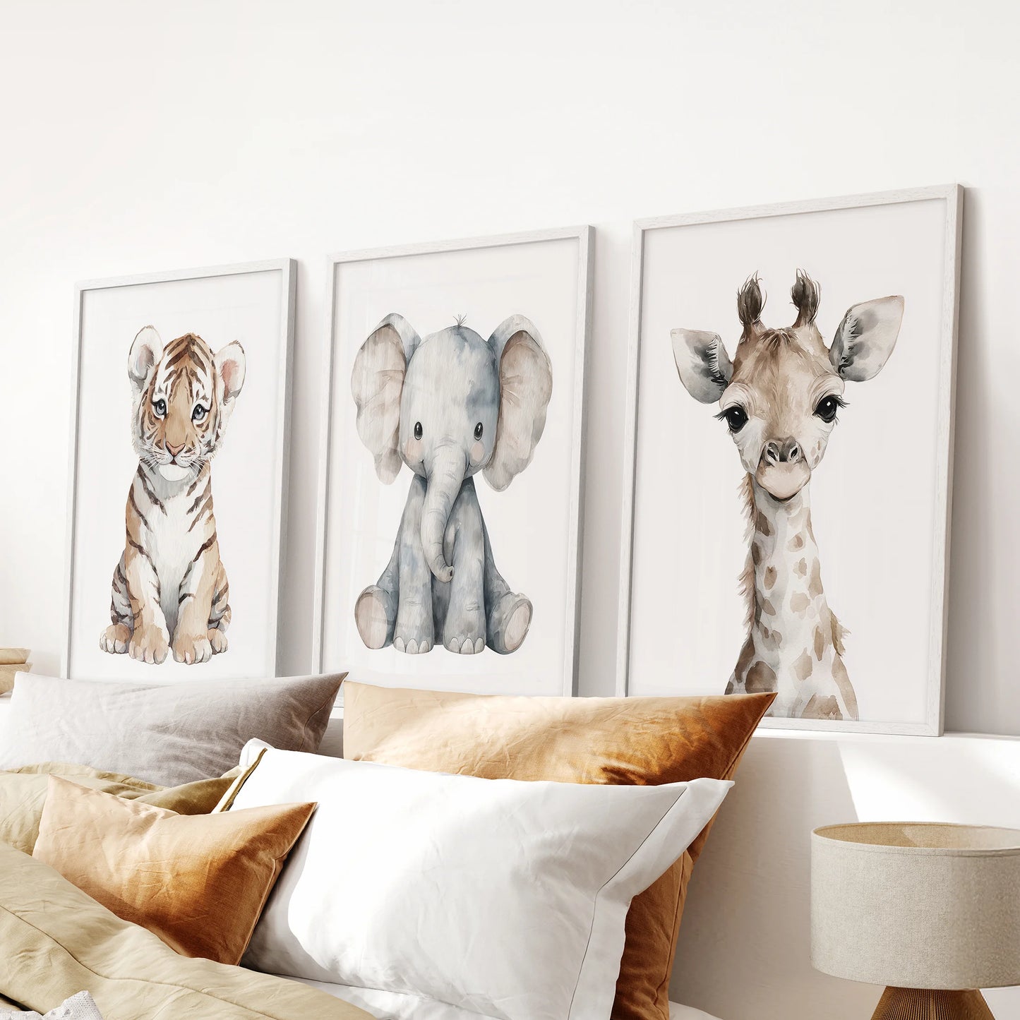 Safari animal triptych in white frames on a white wall, styled for a baby room. White frames for bedroom.