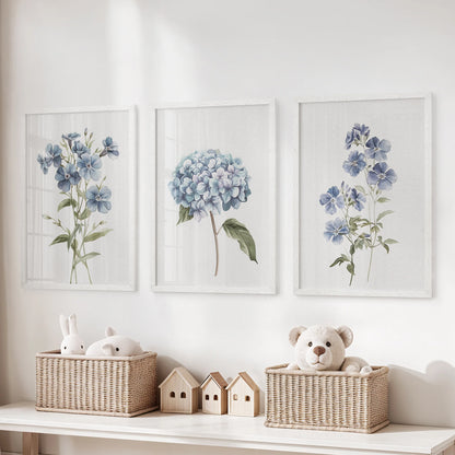 Blue floral watercolors, three-piece wall art in white frames, brighten a children's room above the storage bench with gentle garden tones.