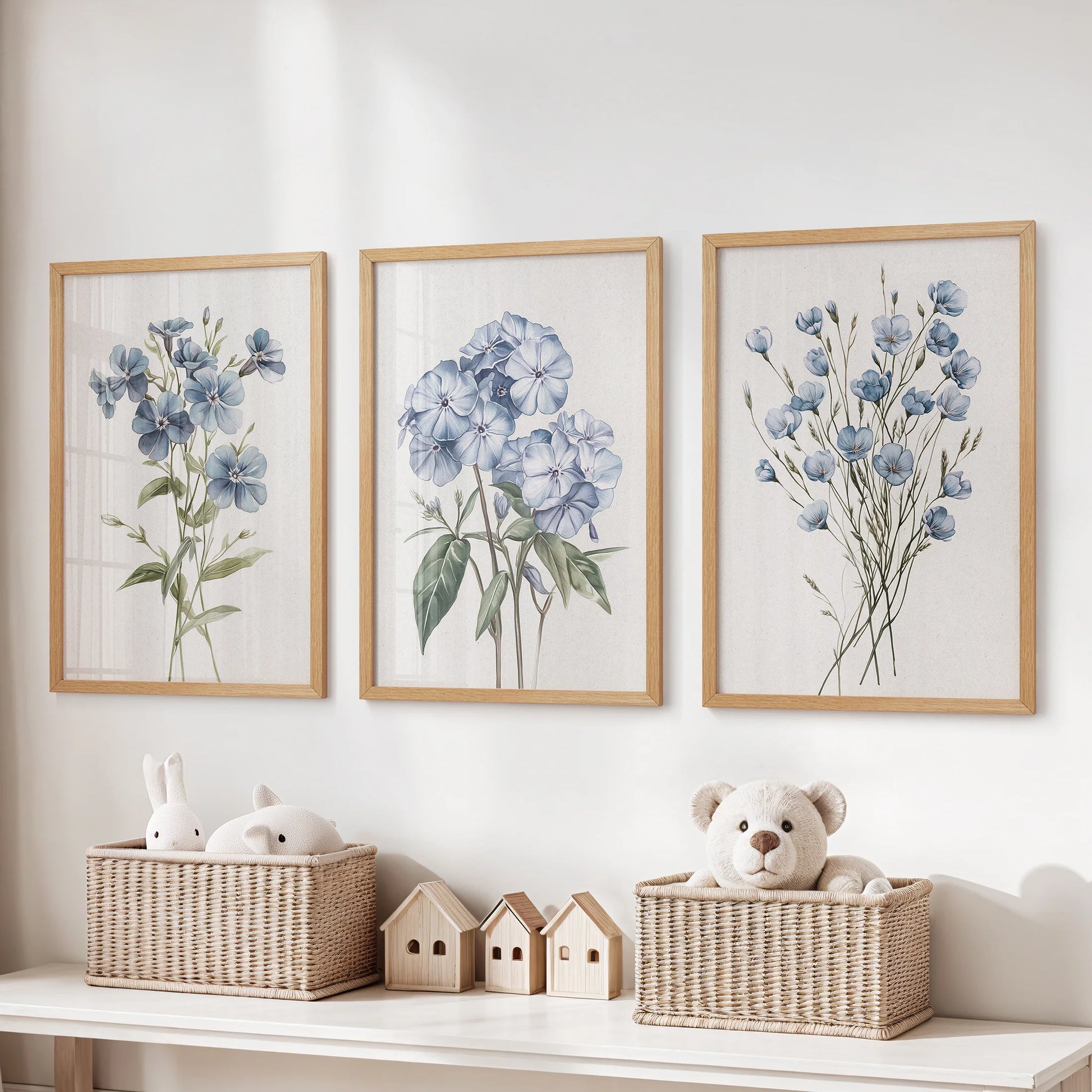 Light blue floral botanical prints, a 3-piece poster set in natural wood frames, hang over the toy storage bench to bring gentle color to the kids room.