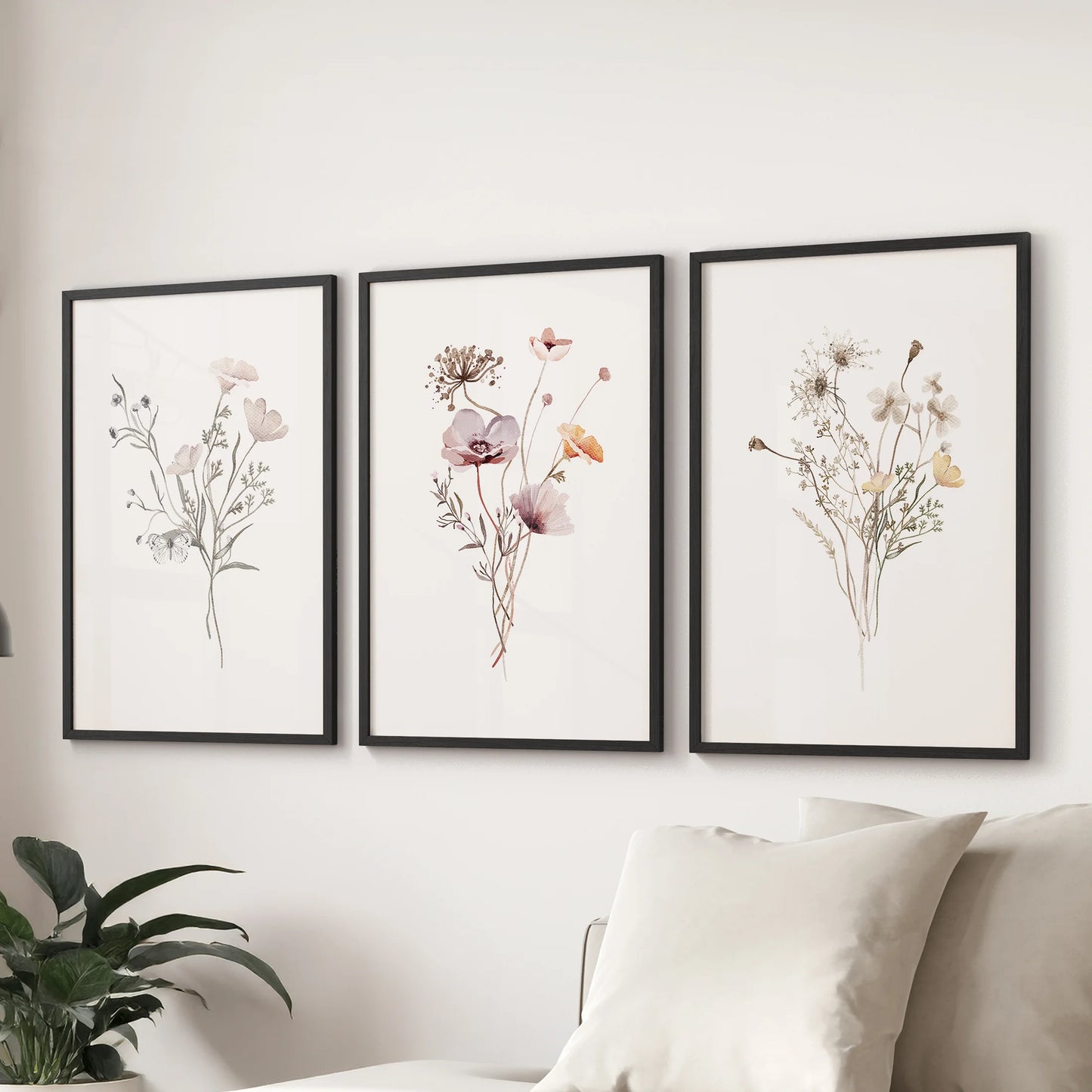 Meadow watercolor blooms wall art, a trio of prints in black frames, floats above the couch to freshen the sitting room with airy color.