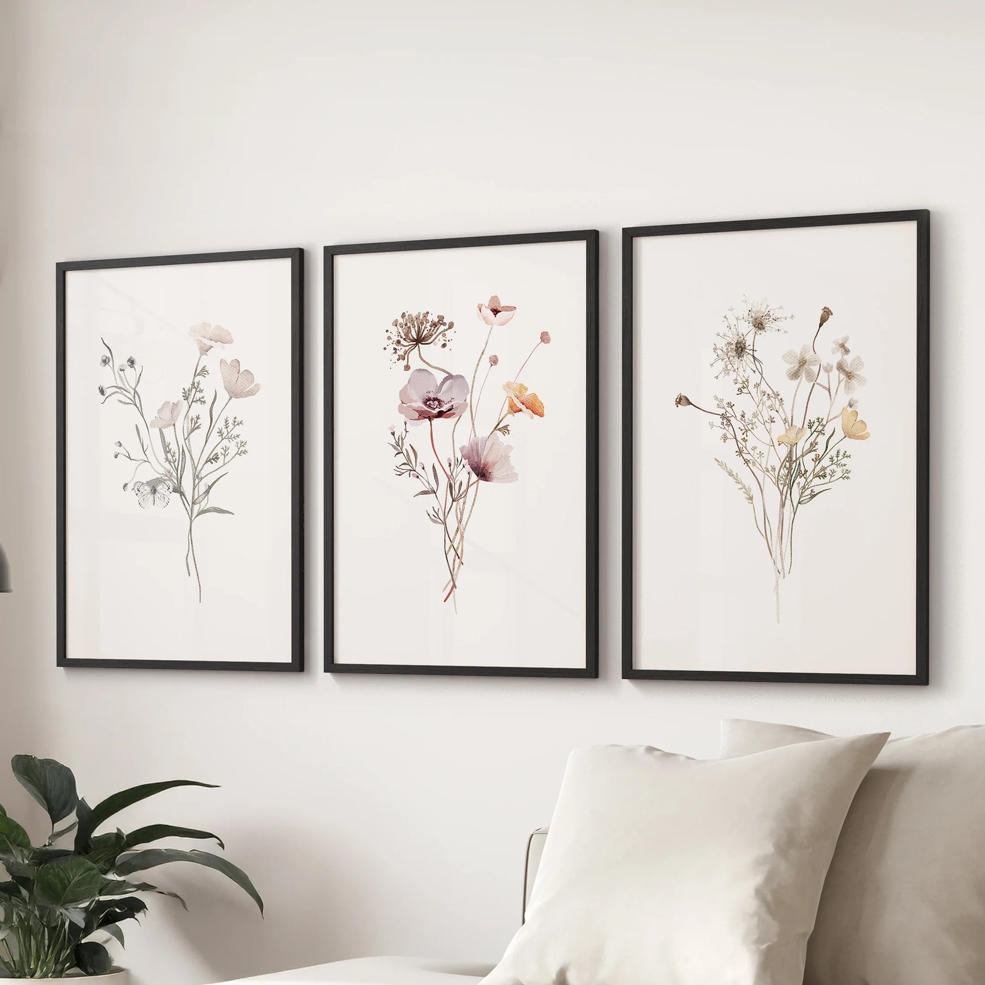 Meadow watercolor blooms wall art, a trio of prints in black frames, floats above the couch to freshen the sitting room with airy color.