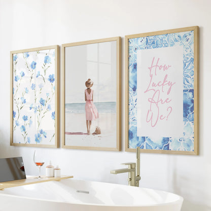 Mounted above the tub, this three-print wall art set of beach girls illustrations in warm wood frames brings playful coastal whimsy to the bathroom.