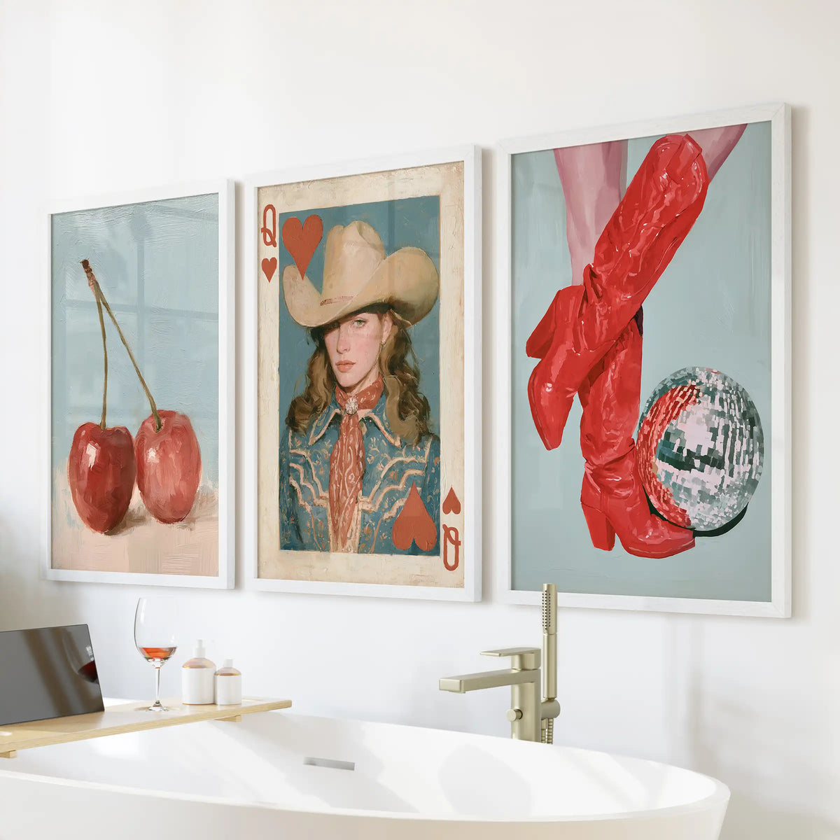 Cherries art set of three posters, cleanly framed in white, hangs over the bath to brighten the bathroom with bold, retro fruit graphics.
