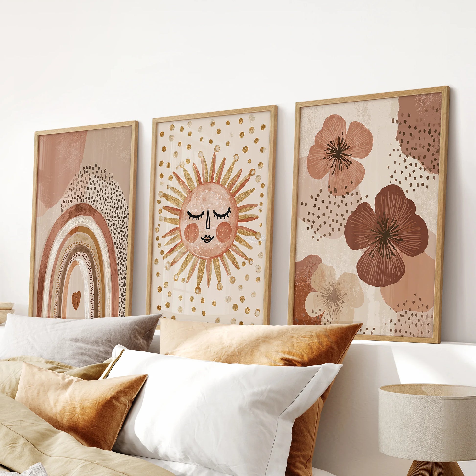 Three-piece rainbow, smiling sun, abstract flowers kids art in light wood frames brings a soothing, nature-inspired tone to the bedroom above the headboard.