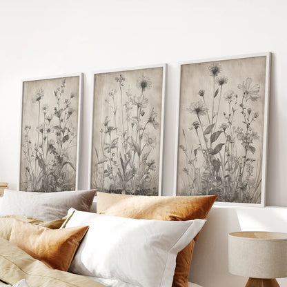 Black flower illustrations, a set of three framed wall prints in white, balance the bedroom and sit neatly above the headboard.