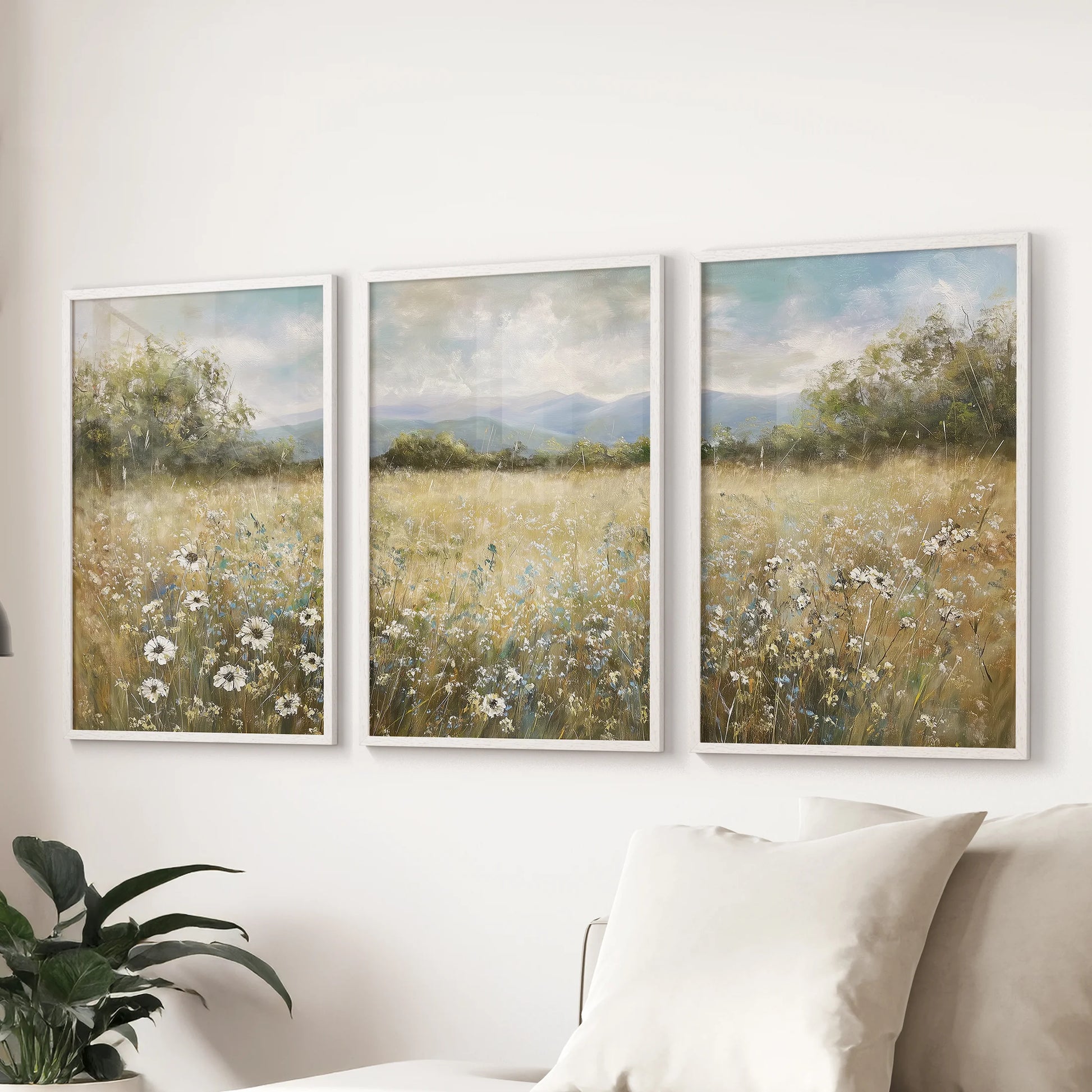 Pastoral countryside landscape neutral painting trio of posters with matte white frames, a calm focal point for the sitting room wall above the sectional.