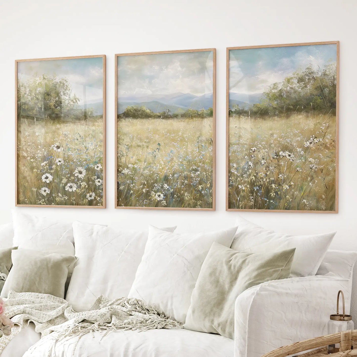 Wildflower meadow wall art set of 3 with daisies and mountains. Thinwood frames over the couch.