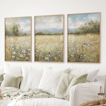 Wildflower meadow wall art set of 3 with daisies and mountains. Thinwood frames over the couch.