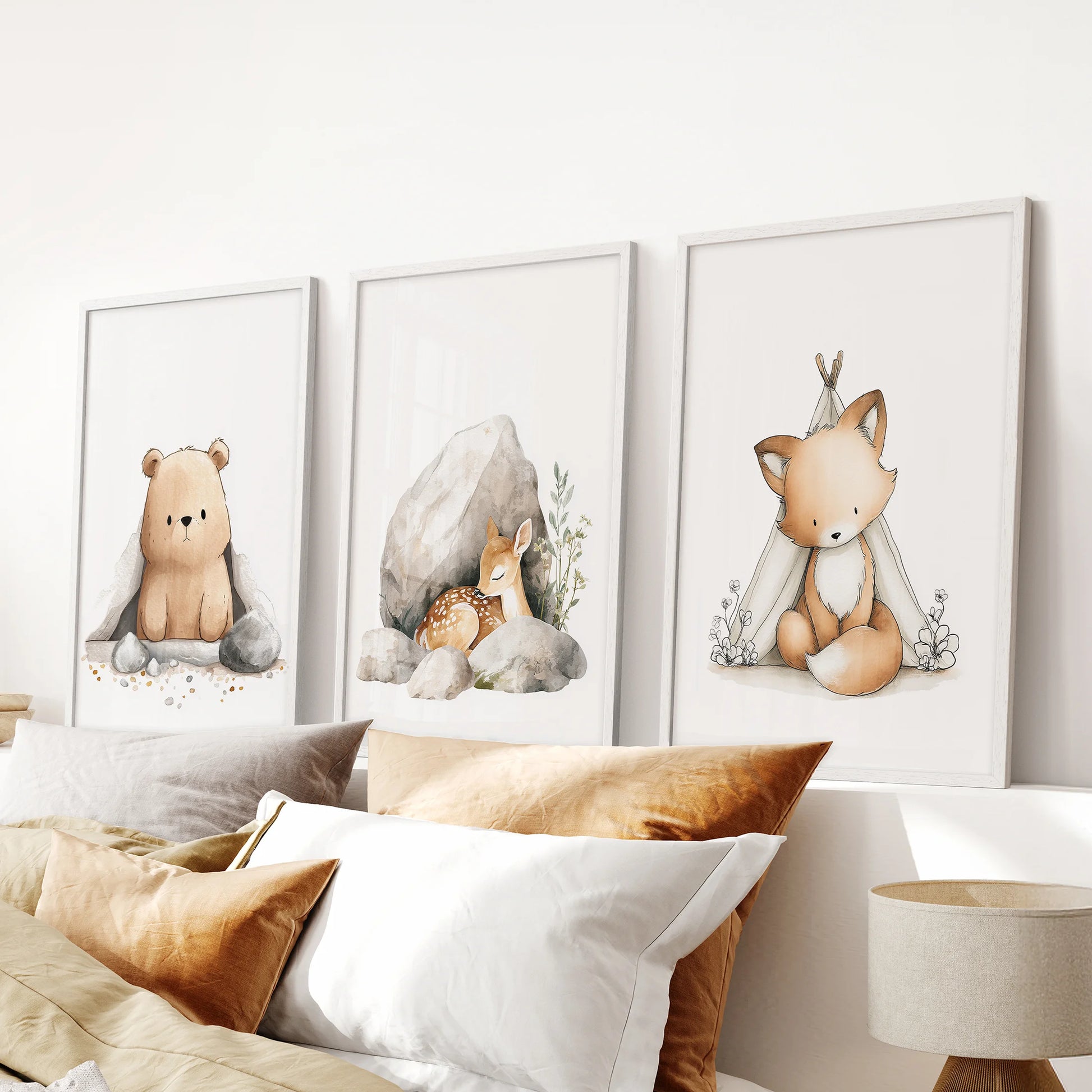 Bear, fox and deer wall art, a 3-piece picture set with a clean white frame finish, centers the space over the bed in a peaceful bedroom.
