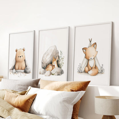 Bear, fox and deer wall art, a 3-piece picture set with a clean white frame finish, centers the space over the bed in a peaceful bedroom.