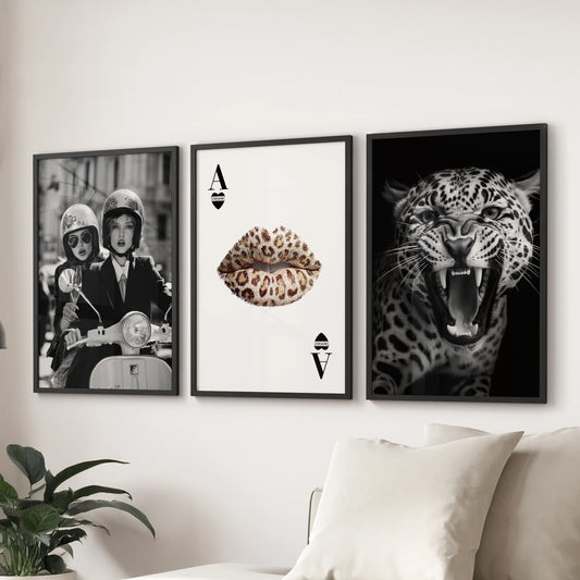 Gallery wall of three Vogue-inspired art prints in black frames, adding a chic focal point over the couch in a contemporary lounge.