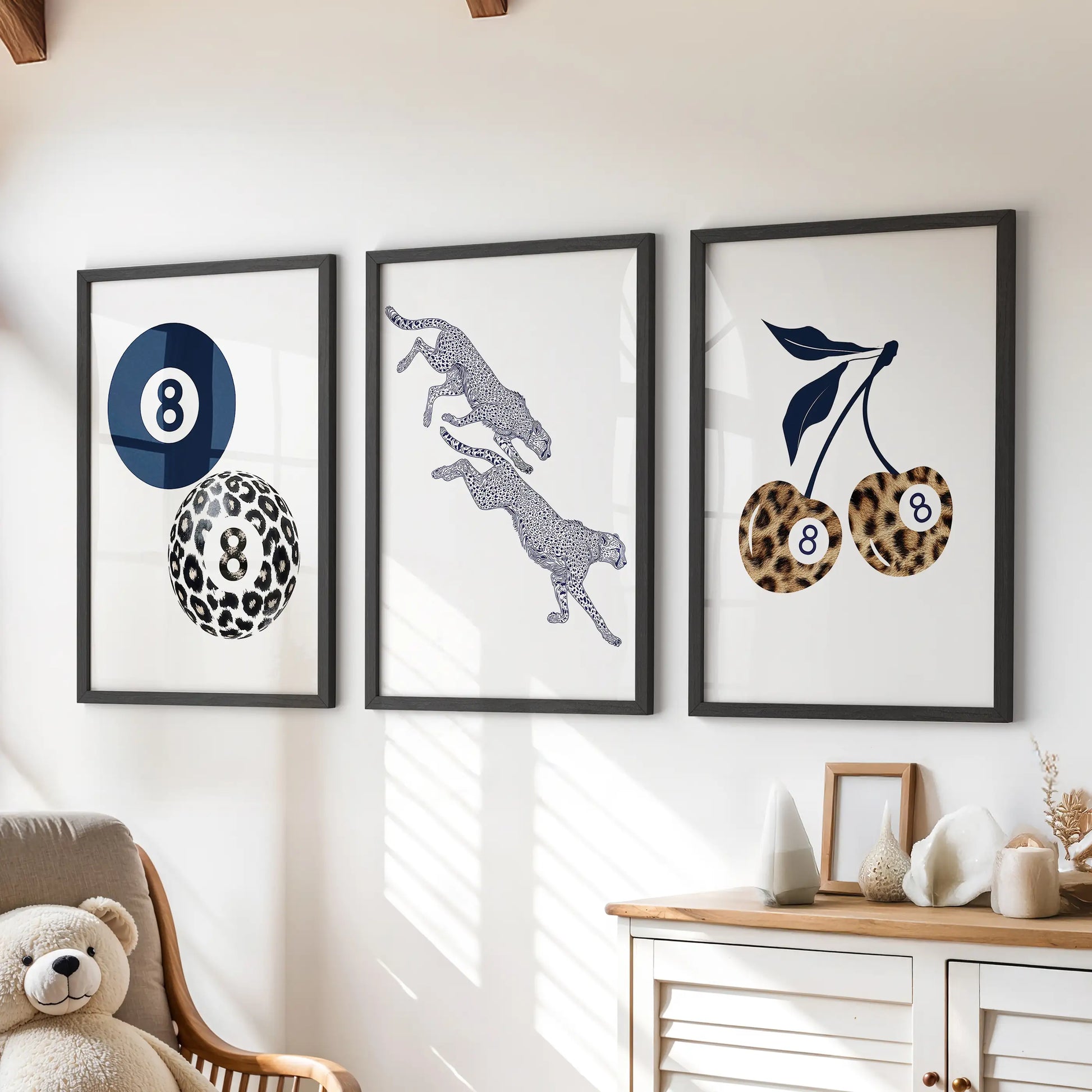 Three navy cheetah prints in black frames form a bold wall art set that adds stylish energy over the playroom chest of drawers.