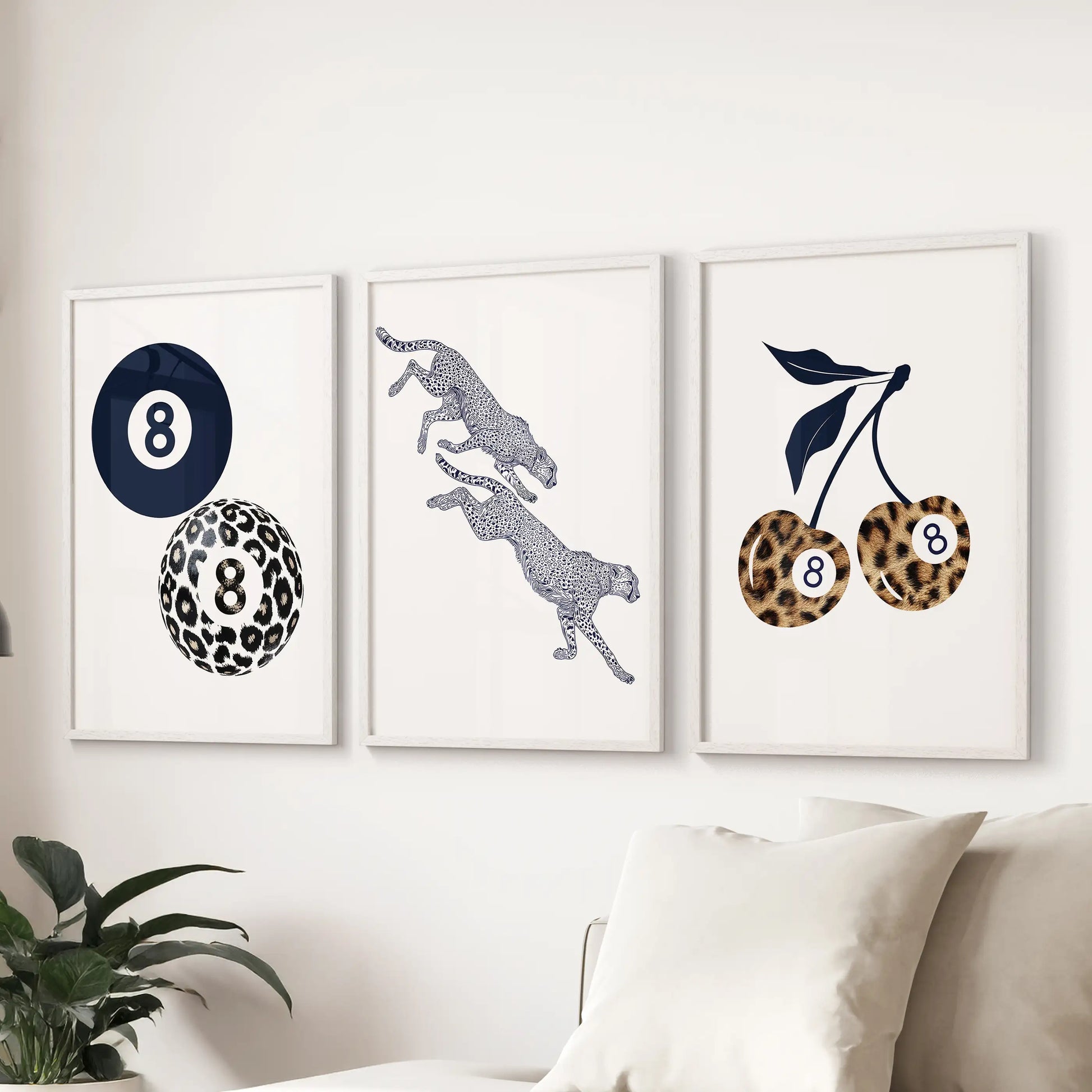 Set of three leopard-pattern prints in clean white frames brings graphic charm to the sitting room wall above the couch.