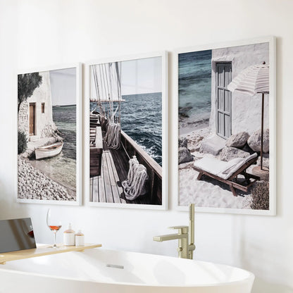 Mediterranean sailboats, a set of 3 wall prints in white frames, placed above the tub to lend a light sea-breeze feel to the bathroom.